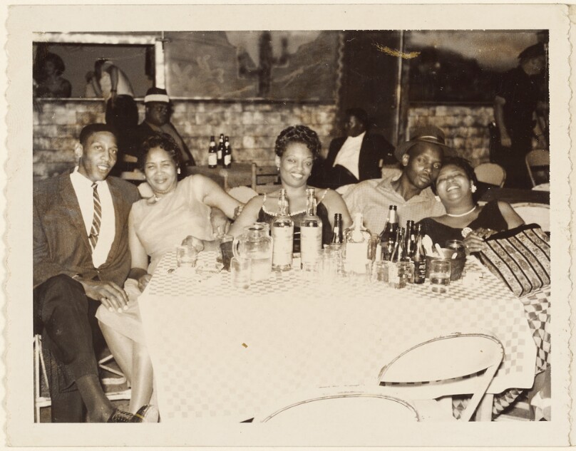 [Group portrait at restaurant table]