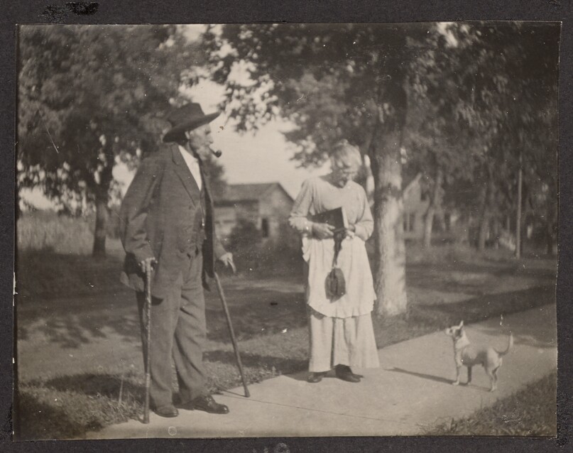 [Elderly man and woman with a dog]