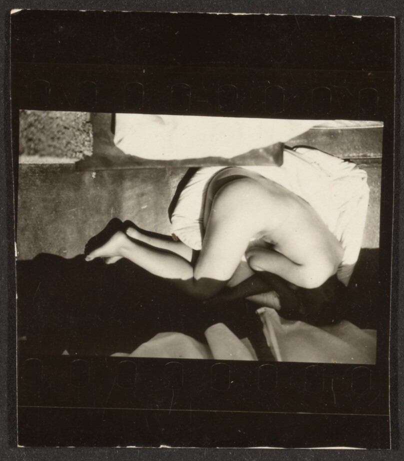[Contact print from 37mm negative: black border above and below image with reclining nude woman seen from above]