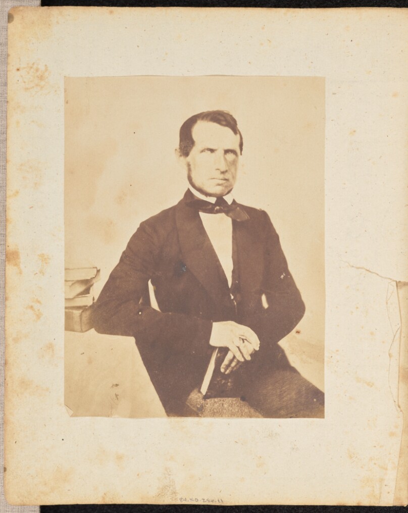 [Portrait of a man with books]