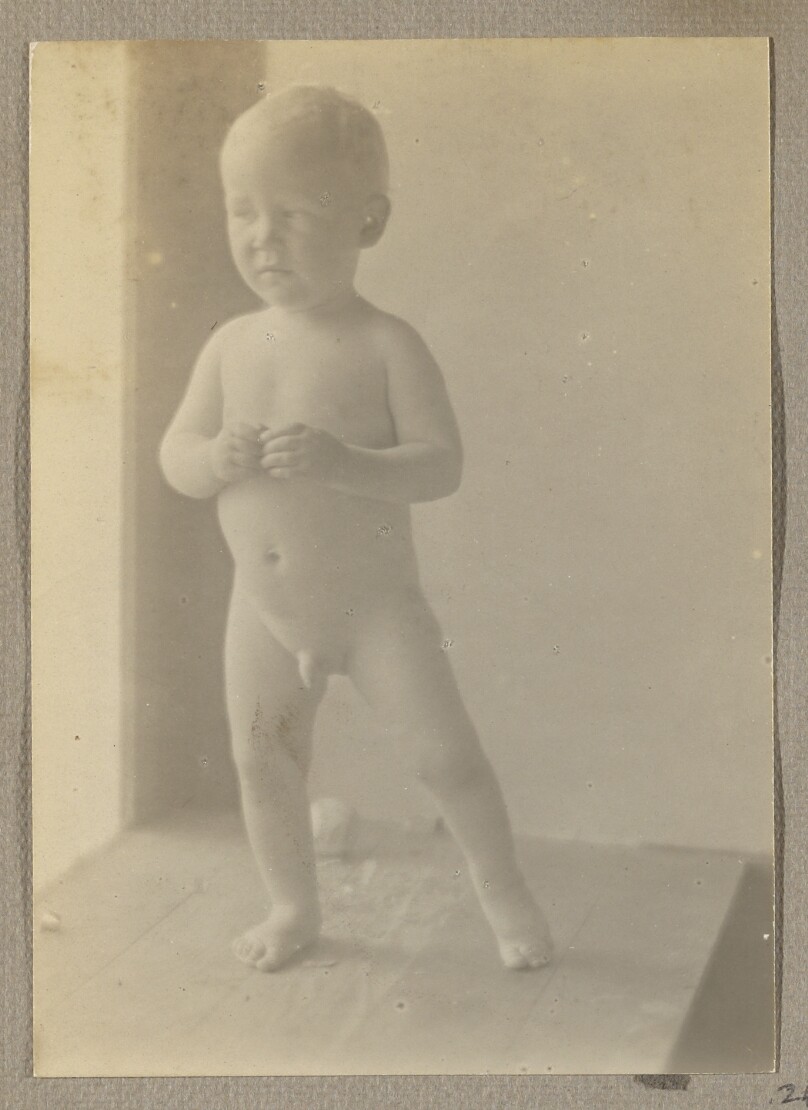 [Neil Weston nude, standing on wood shelf, window to left]