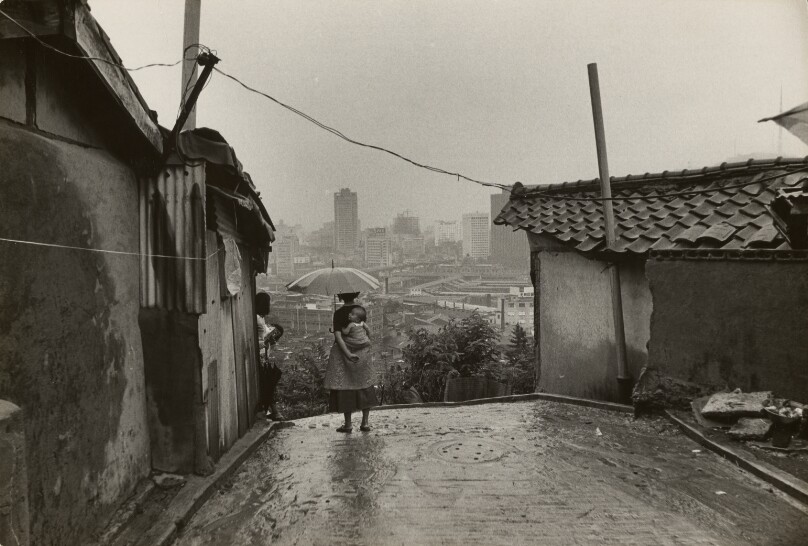 Woman with Baby and Umbrella, Looking over Seoul