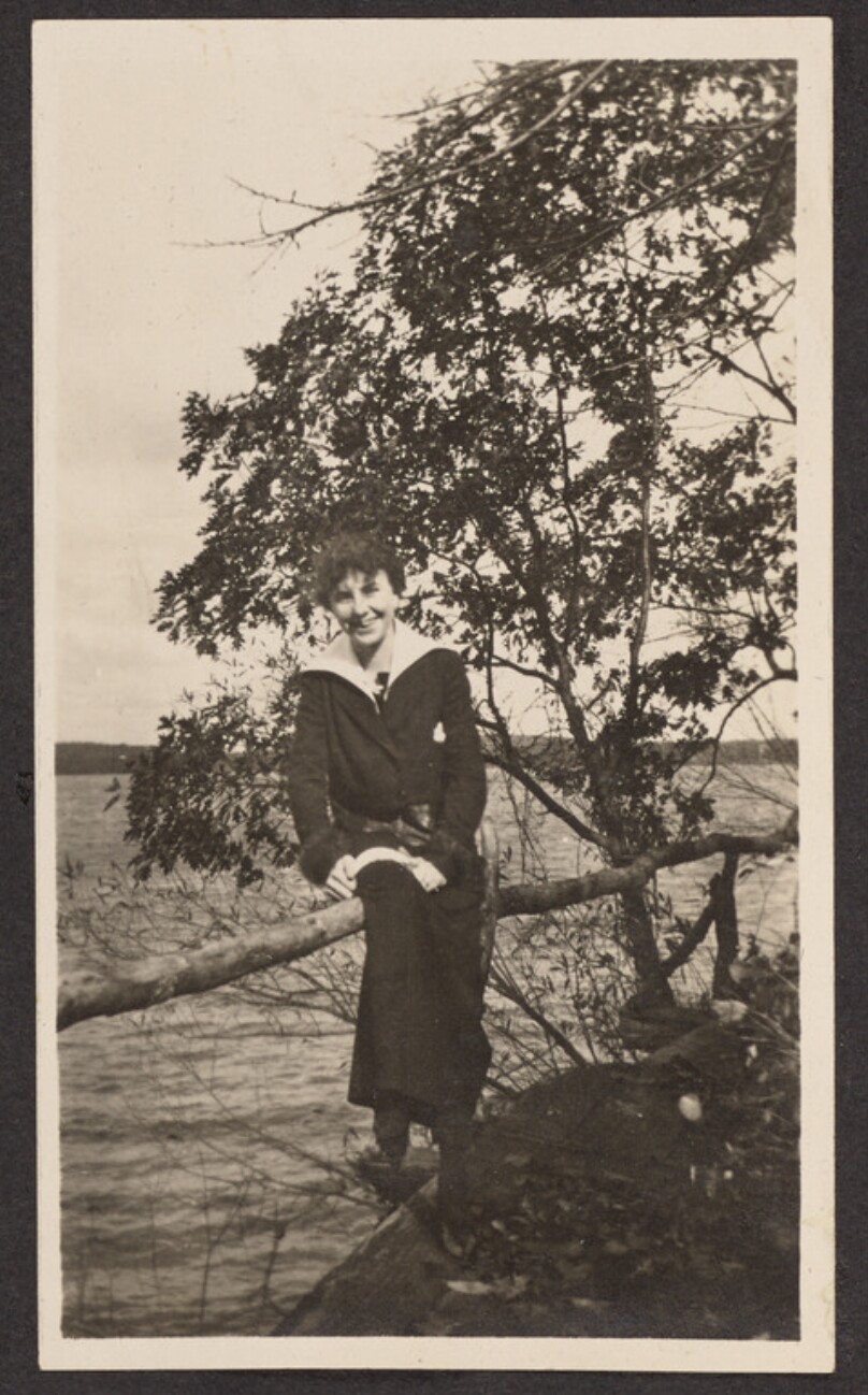 [Woman posing at the edge of a lake]