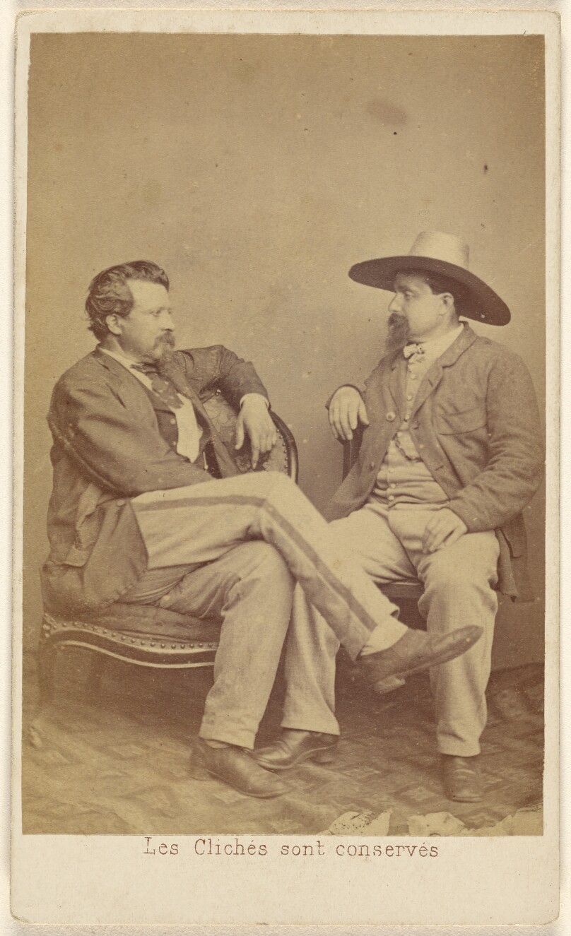 [Two unidentified men seated: one with a moustache, the other with a Vandyke beard and wearing a hat]