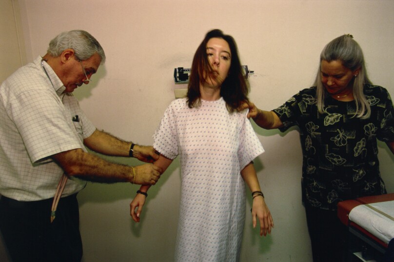 Erin, 24, is blind-weighed at an eating-disorder clinic, Coconut Creek, Florida. She has asked to mount the scale backward so as not to see her weight gain.