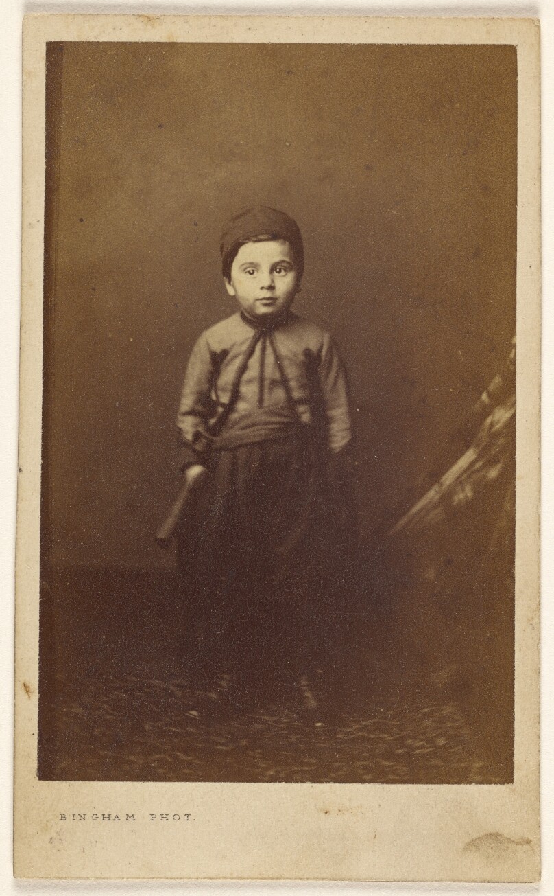 [Unidentified little boy in native costume, standing]