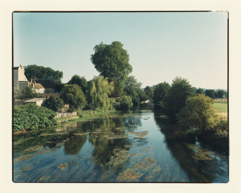 [river from center of bridge, houses left]