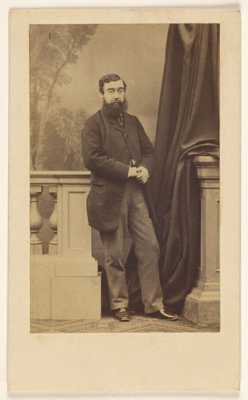 [Full-bearded man, standing]
