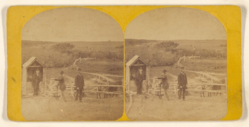 [Three men in bowler hats standing in a corral]