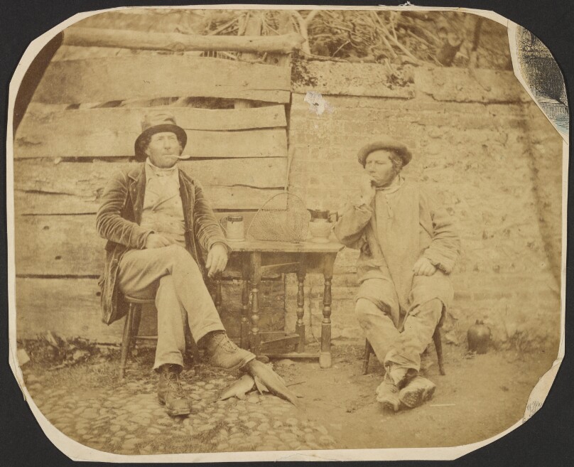 [Two men at table]