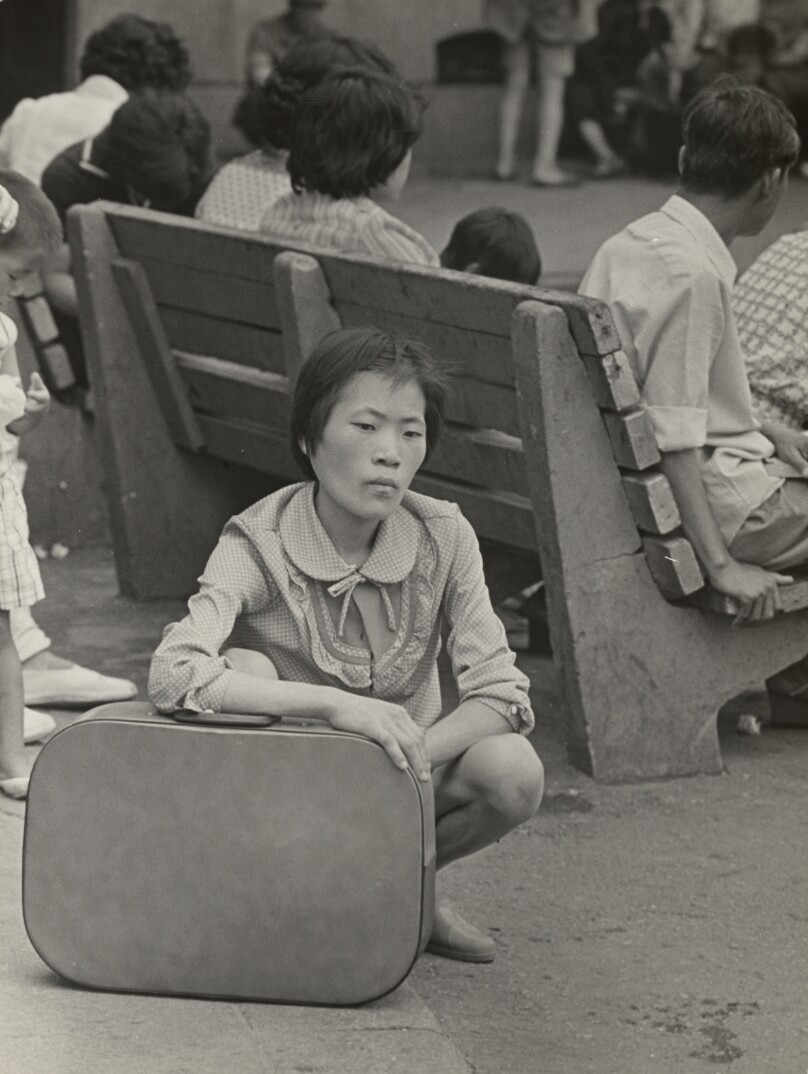 Squatting Woman with Luggage