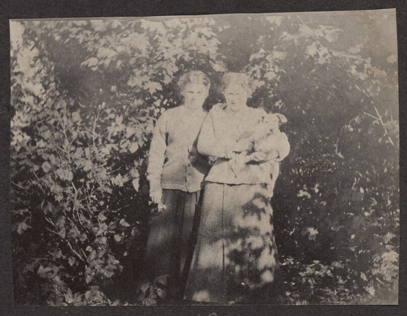 [Two women with a small dog]
