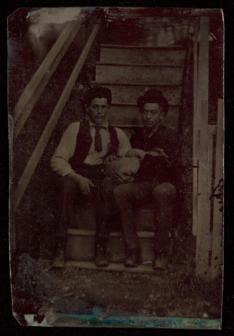 [Portrait of Two Young Men in hats Holding a Goose]