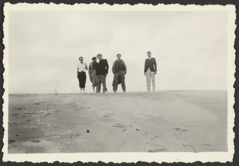 [Group of men and women in sand]