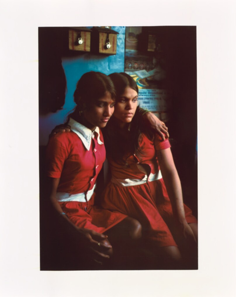 Putla and Rekha in matching red dresses.