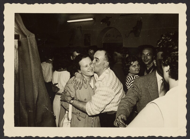 [Man and woman embracing on dance floor]