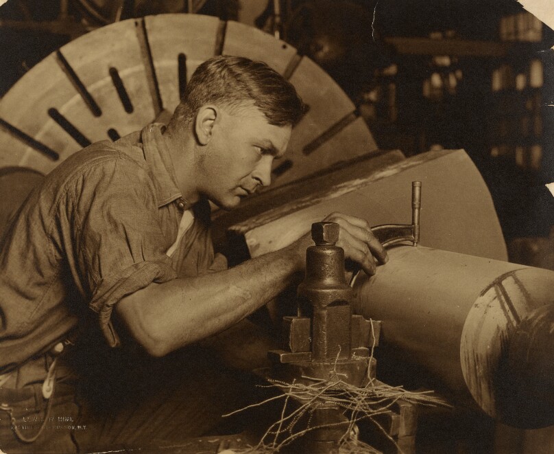 Man with Micrometer Measuring a Shaft to a Thousandth of an Inch.