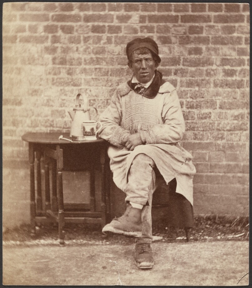 [Man in a Smock Seated at a Table]