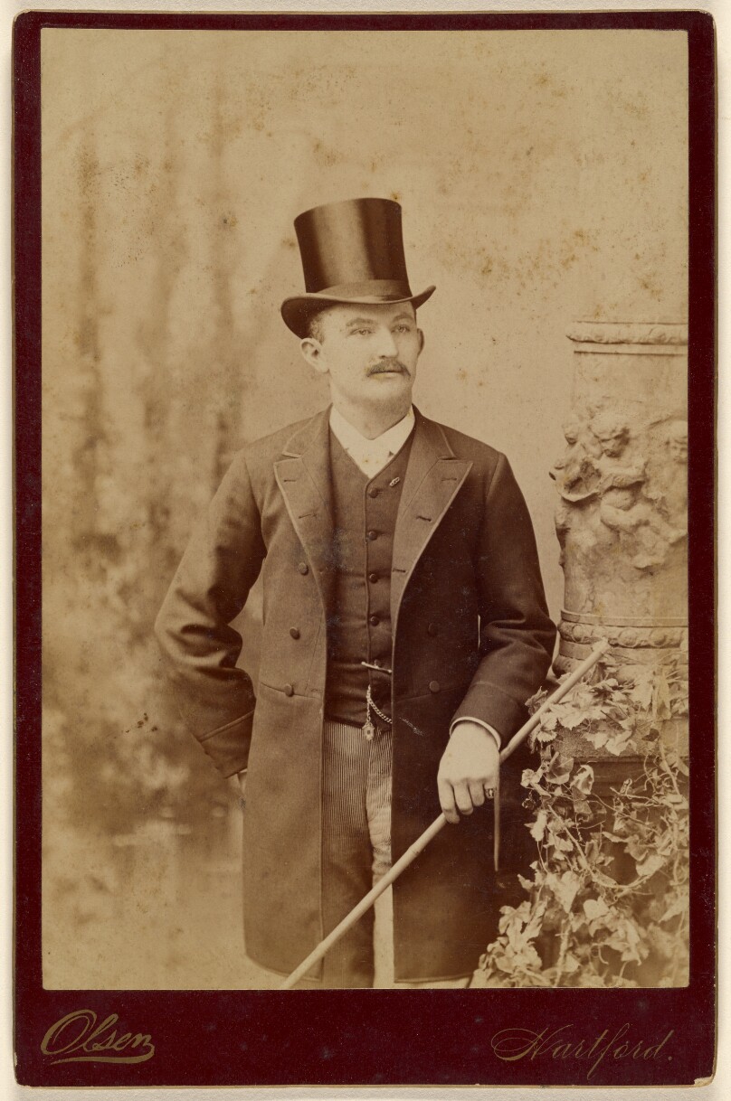 [Unidentified man with moustache, wearing top hat, standing]