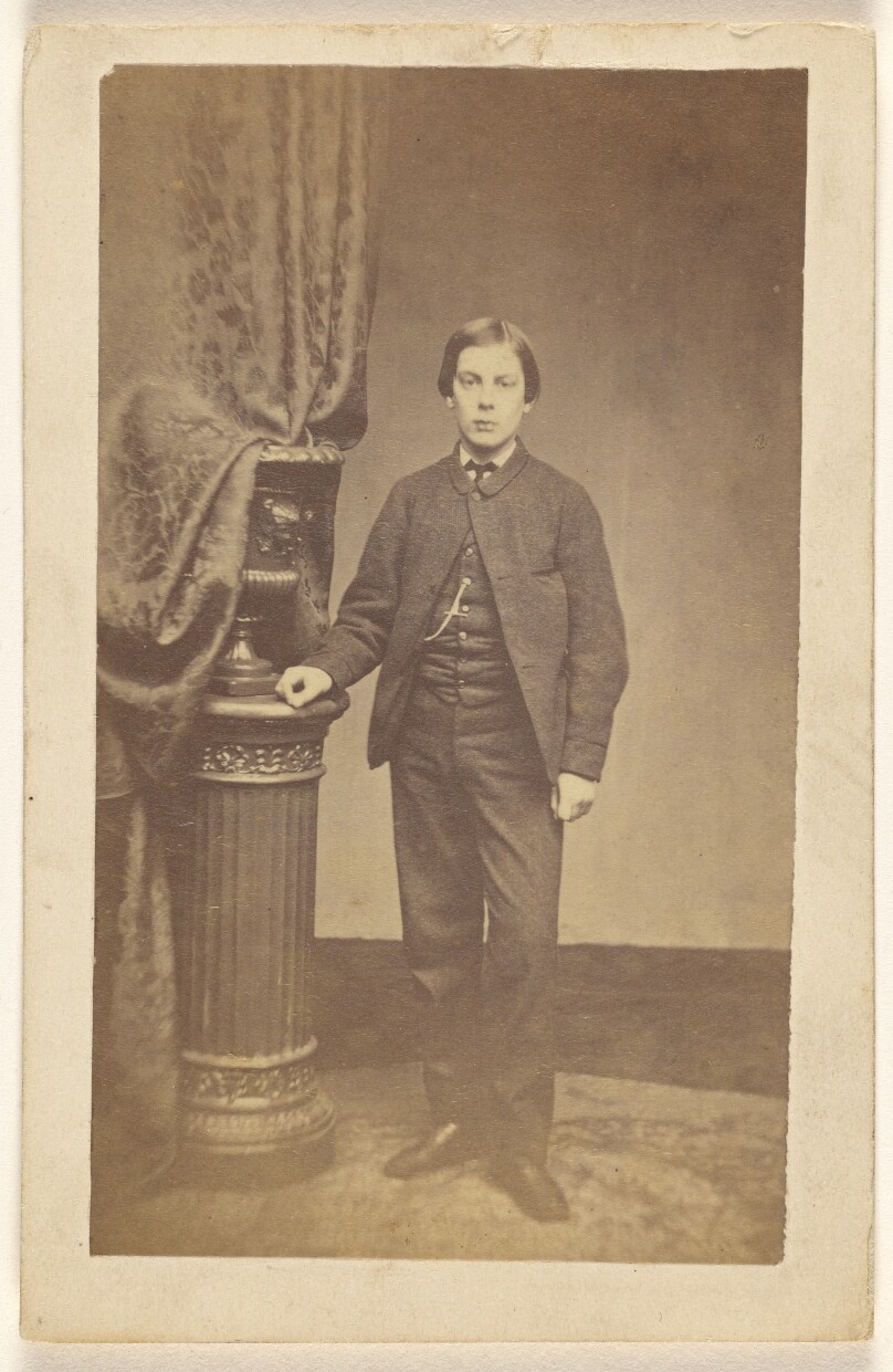 [Unidentified well-dressed young man, standing]