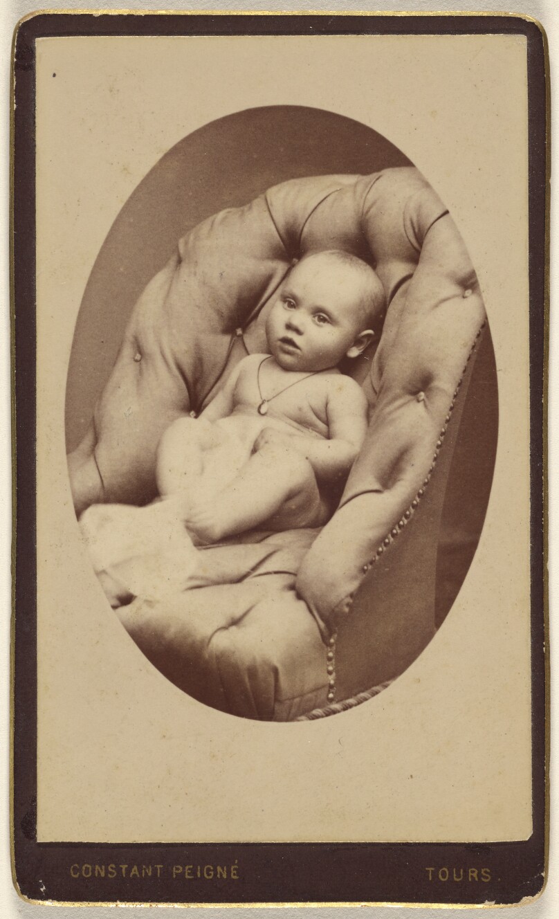[Unidentified baby seated in a leather arm chair]