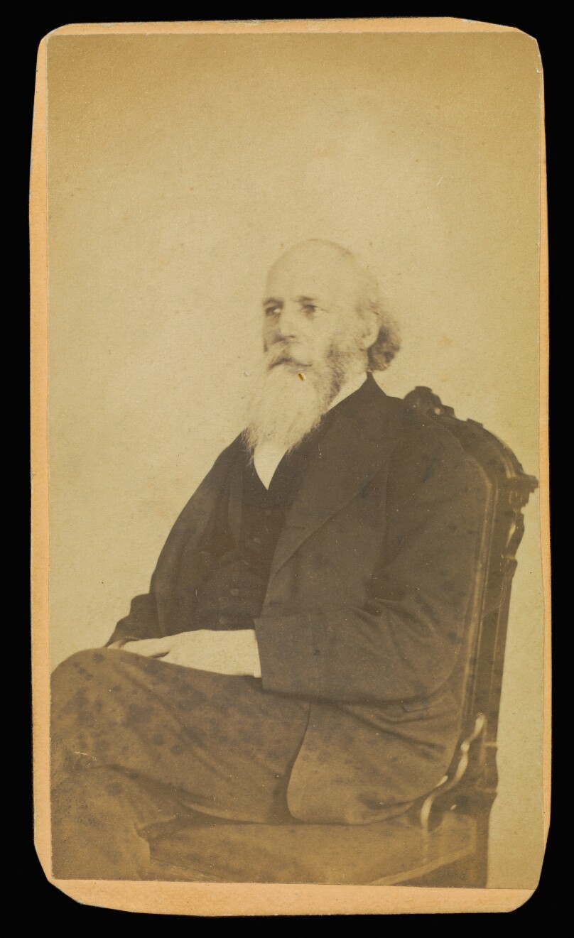 [Unidentified balding man with a long white beard, seated]