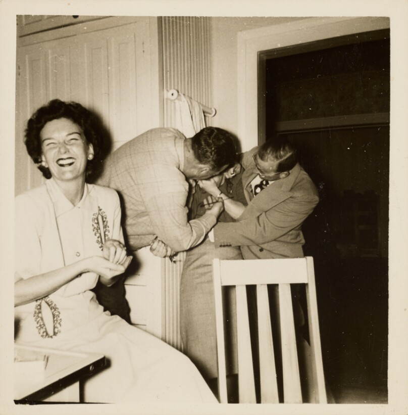 [Woman laughing with three men]