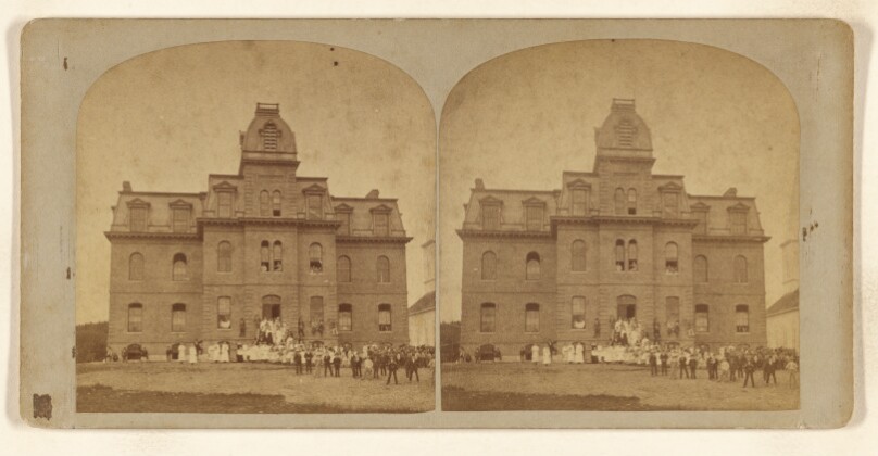 [View of a building with large group of people at front lawn area, probably at Franklin Falls, New Hampshire]