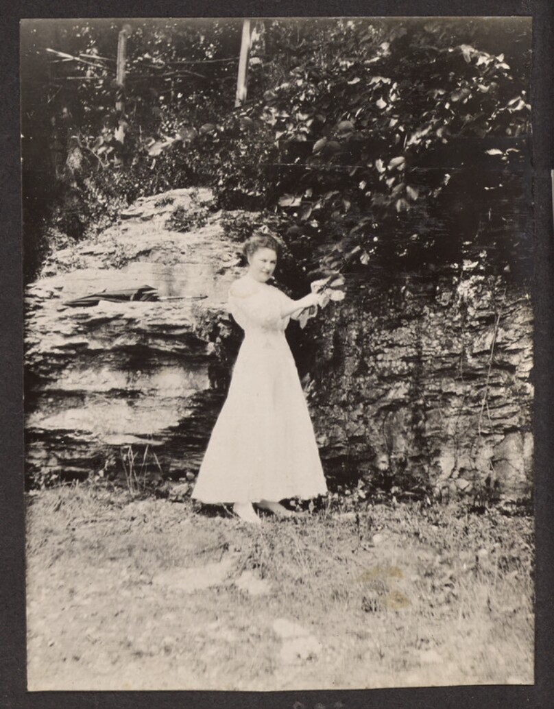 [Woman holding a tree branch]