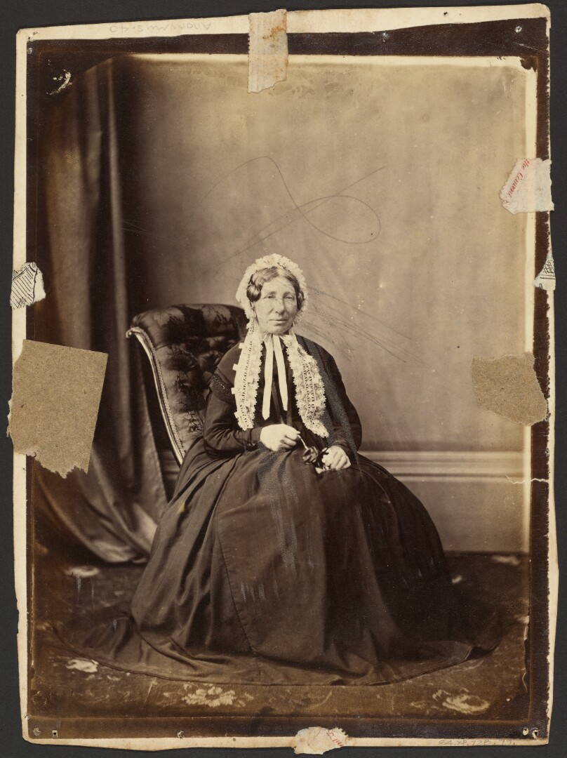 [Seated woman in bonnet]