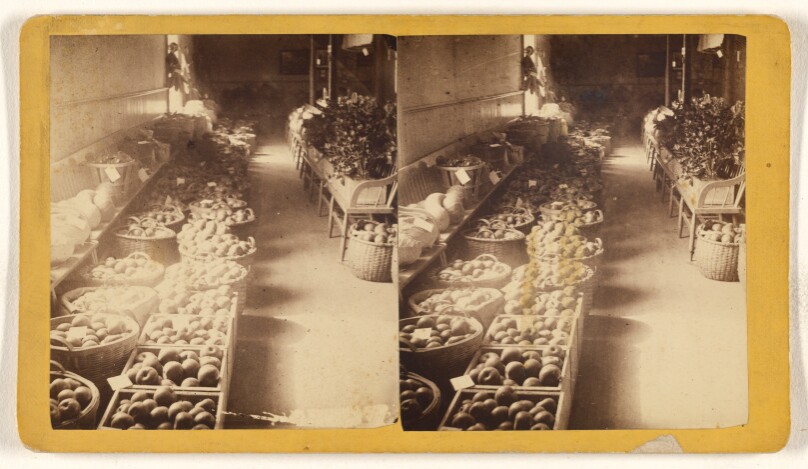 [Baskets of fruits and vegetables at an interior marketplace]