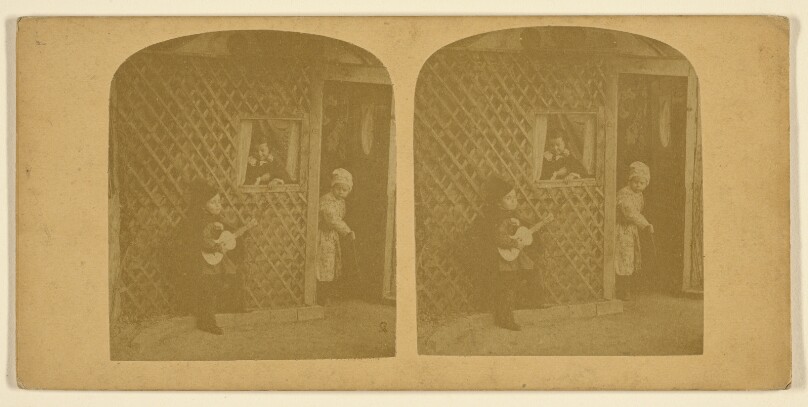 [Three children playing, one boy with guitar]