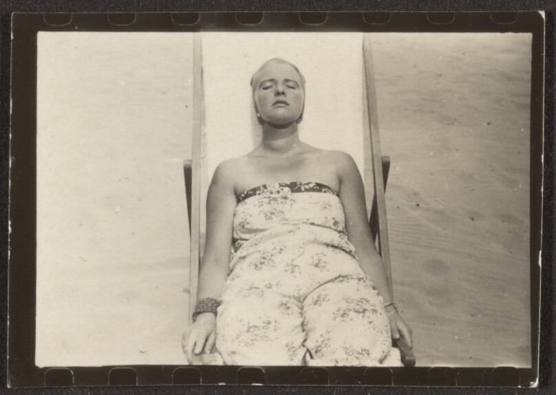 [Contact print from single 37mm negative: woman on deck chair seen from falls]