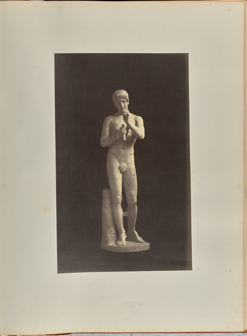 [Statue of a nude male figure with a flute]