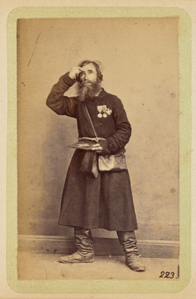 [Man posing with medals on his chest]