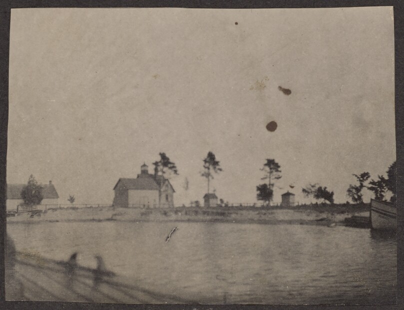 [View of houses and a lake from a boat]