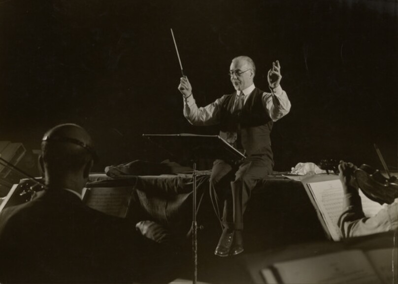 [British Conductor Sir Thomas Beecham, of the London Philharmonic Orchestra, Rehearsing with Musicians]