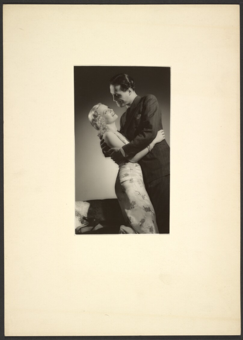 [Man and woman embracing]