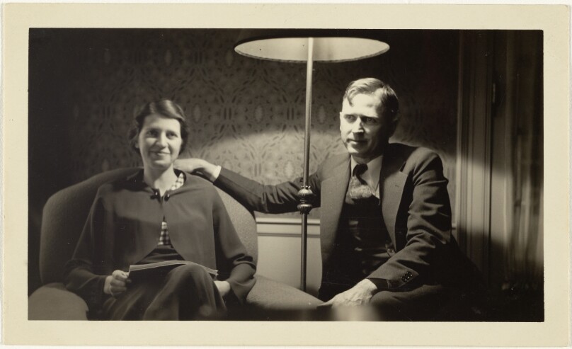 [Man and woman sitting under lamp]