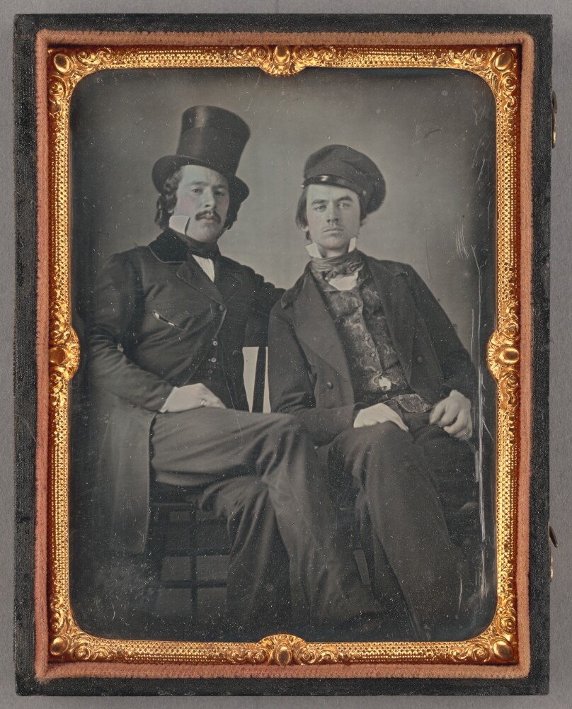 [Portrait of Seated Two Men, One in Top Hat, Another in Cap]