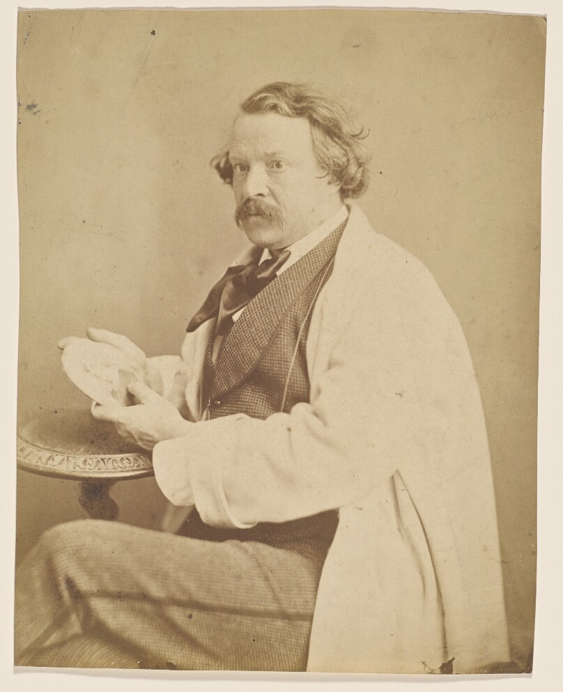 [Self-portrait holding medallion commemorating his deceased mother]