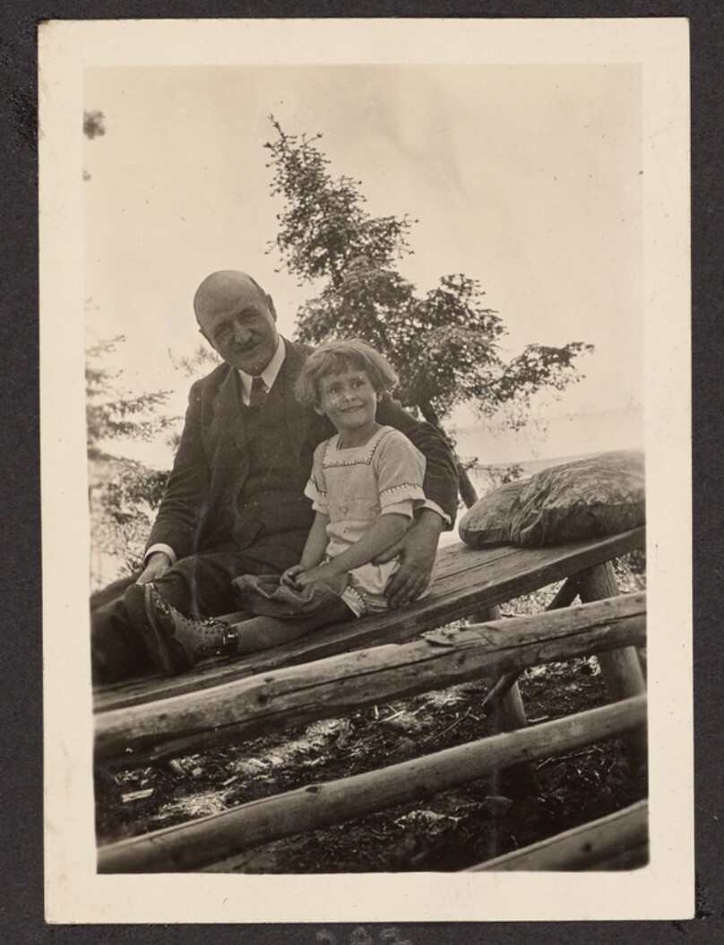 [Man and girl on wood bench]