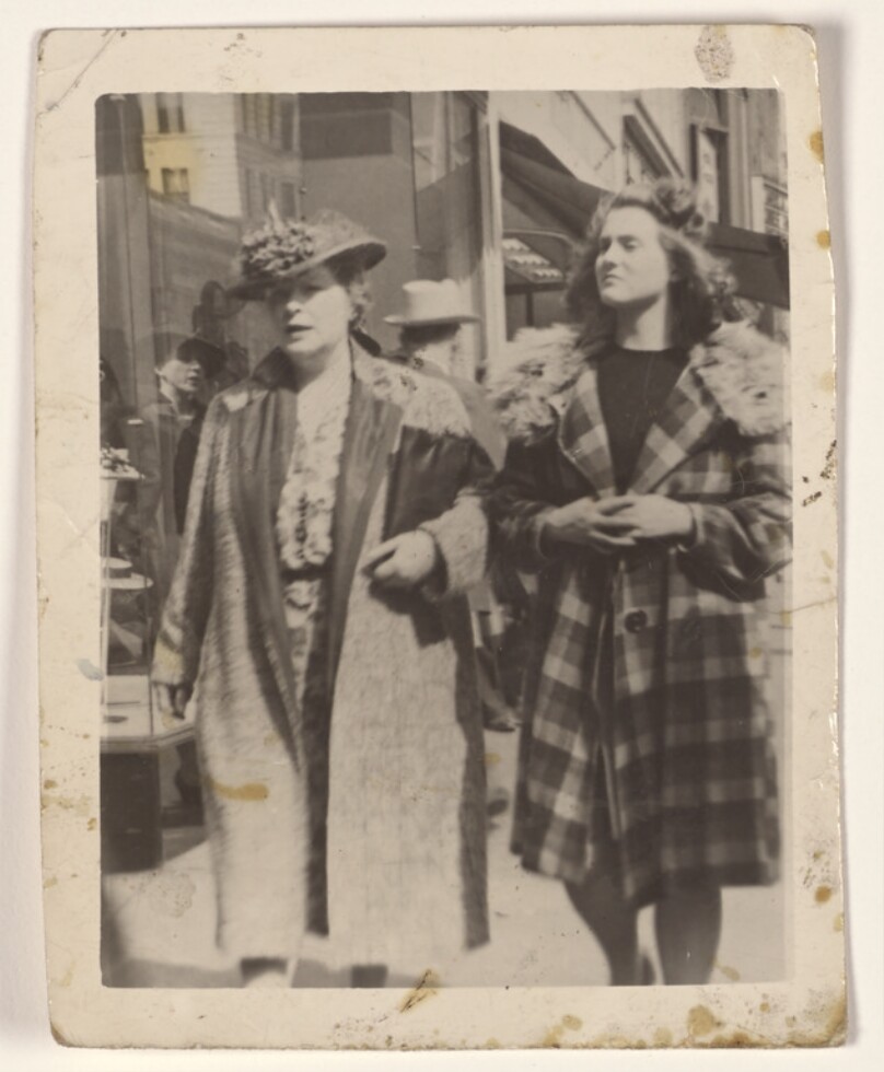 [Two women walking on a sidewalk]