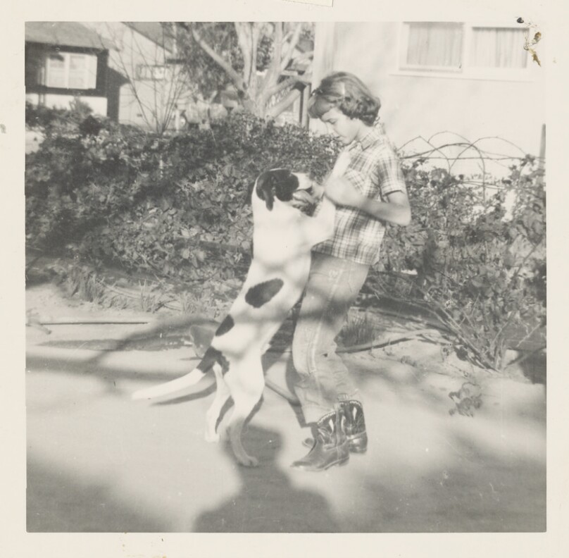 [Girl playing with dog]