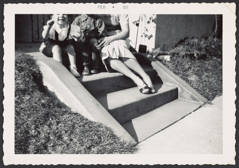 [Woman and children on steps]