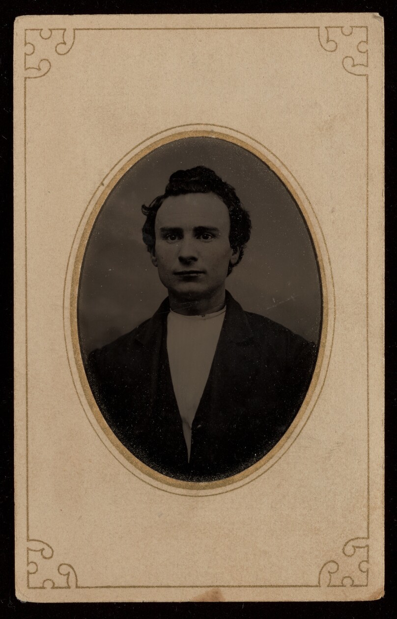 [Unidentified man wearing a collarless shirt and jacket]