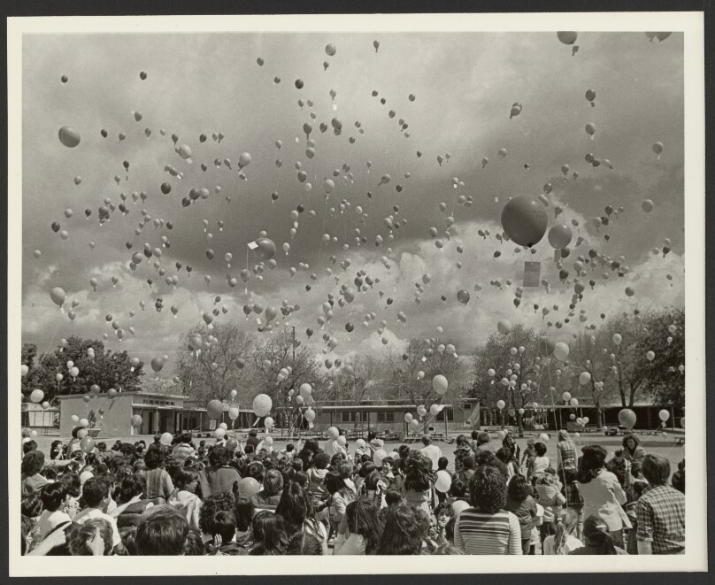 [Children in schoolyard with balloons]