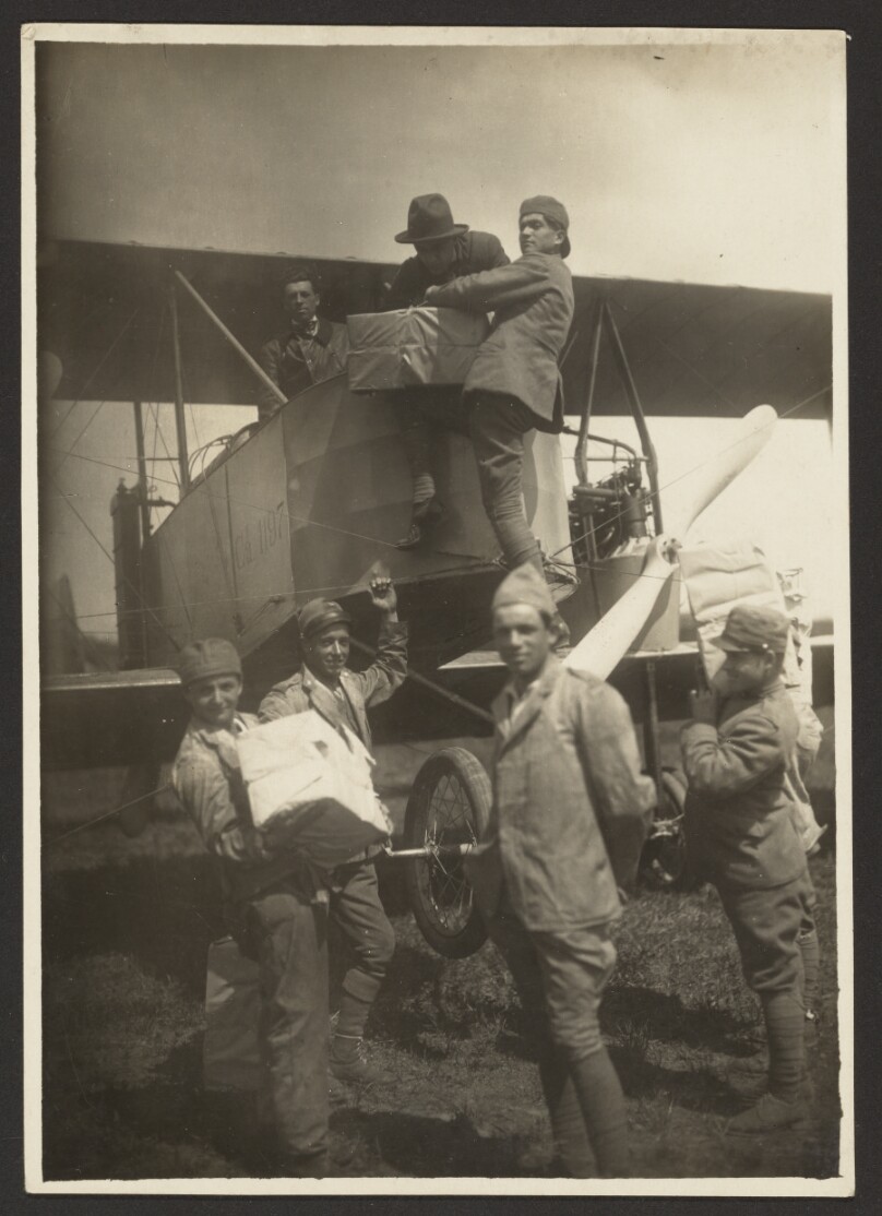 [Soldiers loading supplies in plane]