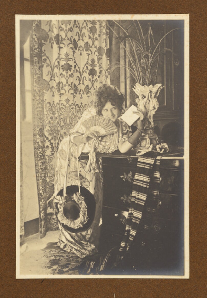 [Woman holding a letter]