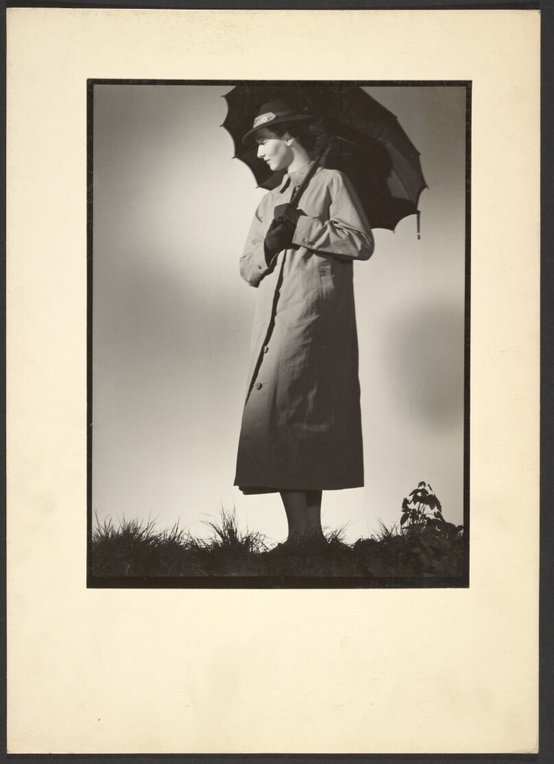 [Woman in coat with umbrella]